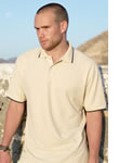 man wears pale embroidered polo shirt